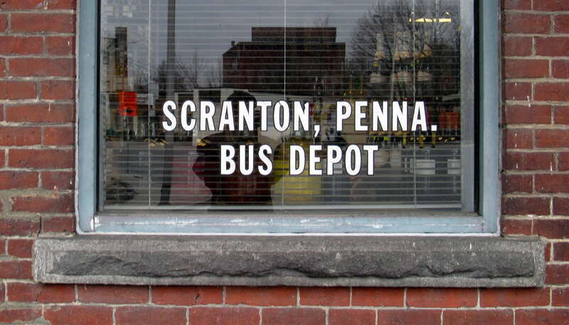 Decal reading &quot;SCRANTON, PENNA. BUS DEPOT&quot; on a window of the former Leominster station in December 2014. The building was used as a set for the 1992 movie School Ties.