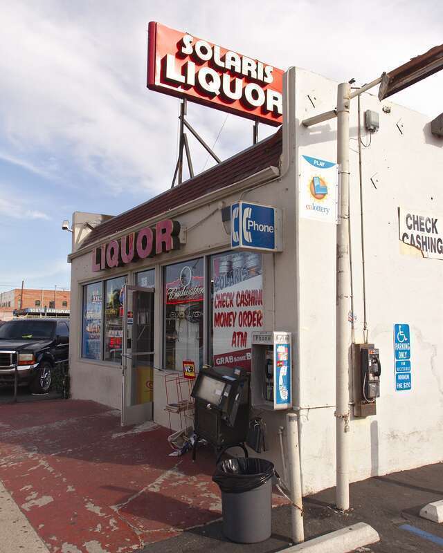 Solaris Liquor in Ventura, California, with an interesting pair of pay phones.