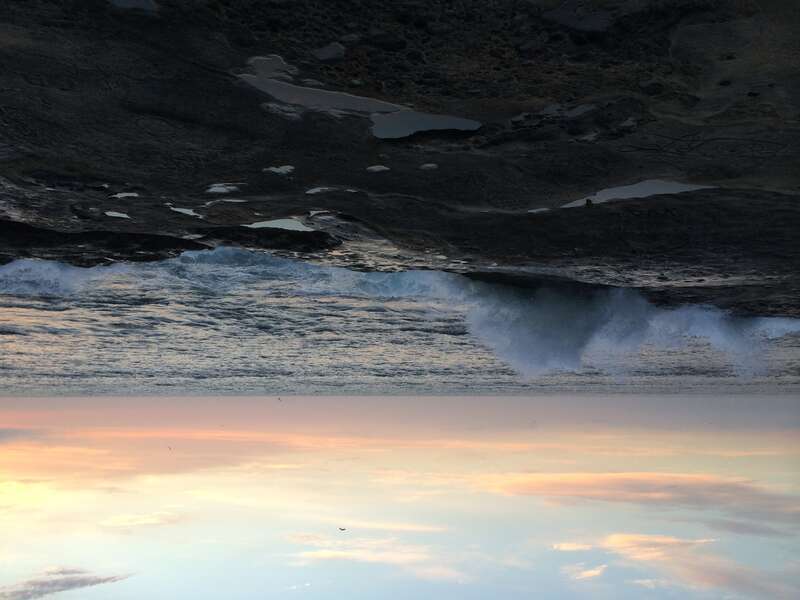 Waves crashing on Ocean Beach as the sun sets.