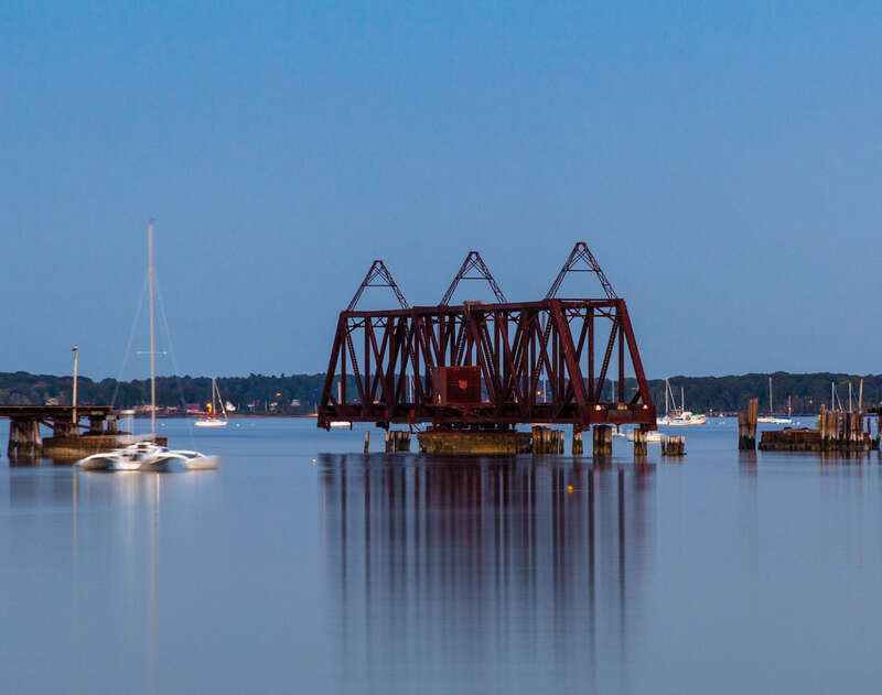 An evening image of the open Back Cove swing bridge.

The rail swing bridge and trestle was built in 1848 when the Atlantic &amp;amp; St. Lawrence railroad began service from Portland to Yarmouth Maine. To cross the Portland peninsula, the trestle was