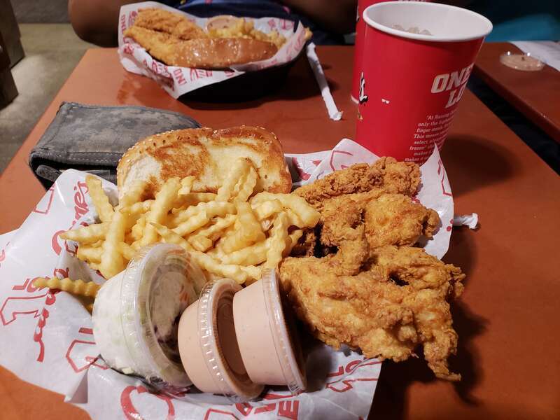 A combination meal of 4 chicken fingers, 2 Cane's sauce, Texas toast, Cole slaw, and a 22oz drink served at the Laguna Hills location of Raising Cane's Chicken Fingers