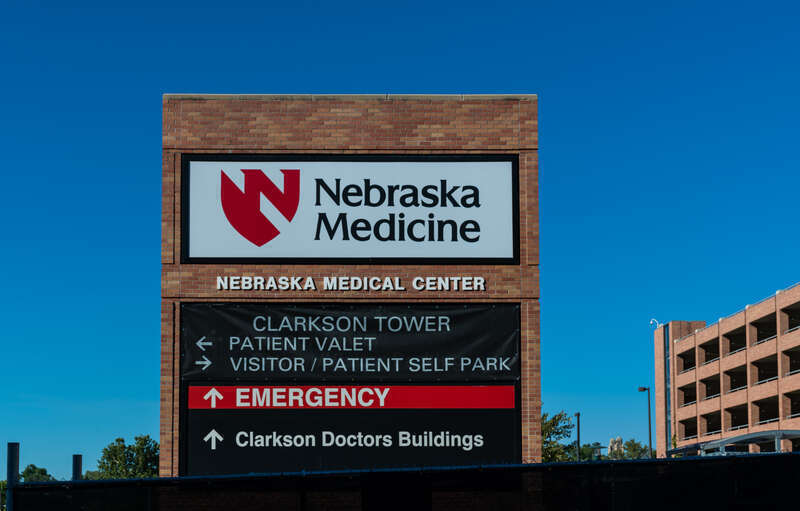 A sign for the University of Nebraska Medical Center campus and emergency room in downtown Omaha, Nebraska.