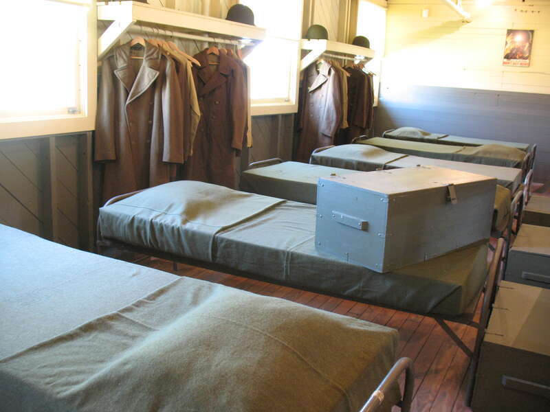 The men slept head to foot to help prevent the spread of disease. 
Besides storing equipment and clothes, the footlocker served as a seat (one was never to sit on the bed). 
World War II Company Street
recreated using historic buildings from