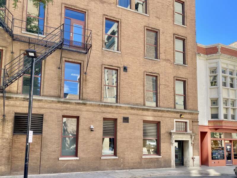 Built in 1900 and expanded in 1908, this Beaux Arts-style flatiron building was designed by Gordon and Paunack to house the Commercial National Bank, and is known as the Wisconsin Building.  The building is flatiron-shaped with a curved corner, and