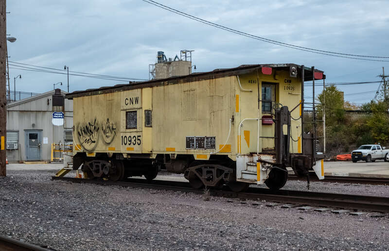 CNW 10935 caboose resting in a Union Pacific yard in Waukegan  Illinois.