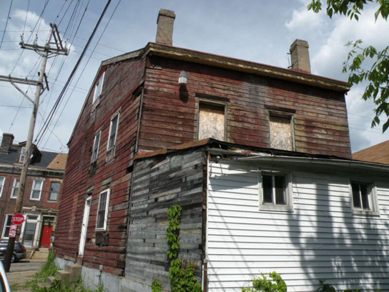 Picture of the back of 184 38th Street (also known as McBride Log House) in the Lawrenceville neighborhood of Pittsburgh, Pennsylvania, on May 21, 2011.  The log house dates back to the 1820s, and was supposedly the oldest known log house that