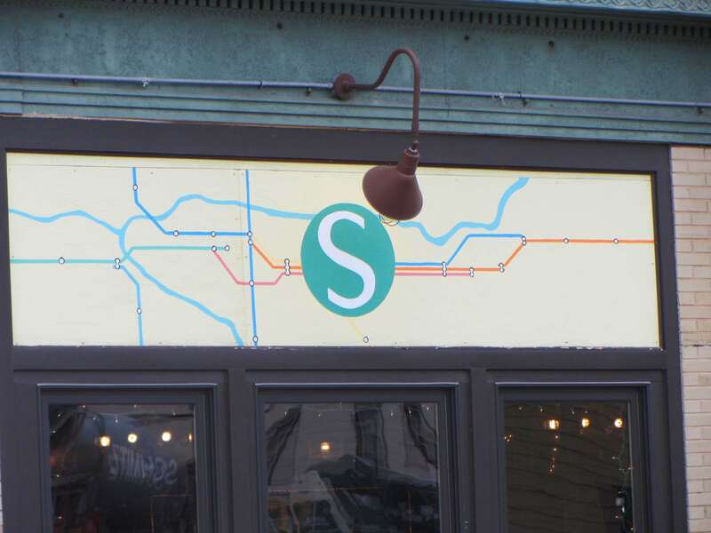 This restaurant has various stylized transit maps above the windows.