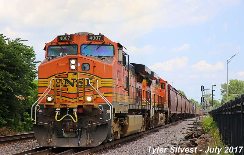 Burlington Northern Santa Fe 4007(C44-9W), 4746(C44-9W) and 7487(ES44DC) Leading a Westbound Covered Hopper on the Emporia Sub near the Loula Street crossing west of Kansas Avenue in Olathe, KS.
Photo Taken: 7-28-17 at 12:33 pm

Picture ID# 6433