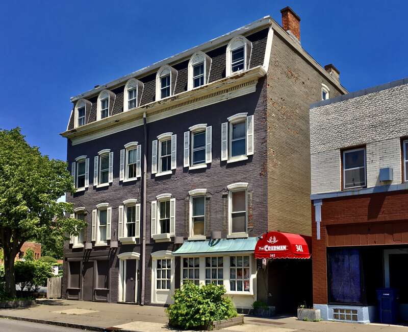 As seen in June 2020: the c. 1854 commercial and apartment building at 341 Franklin Street, Buffalo, New York; a local landmark since 2018, and - with a mansard roof pierced with round arch-topped dormer windows and a scrupulously symmetrical façade