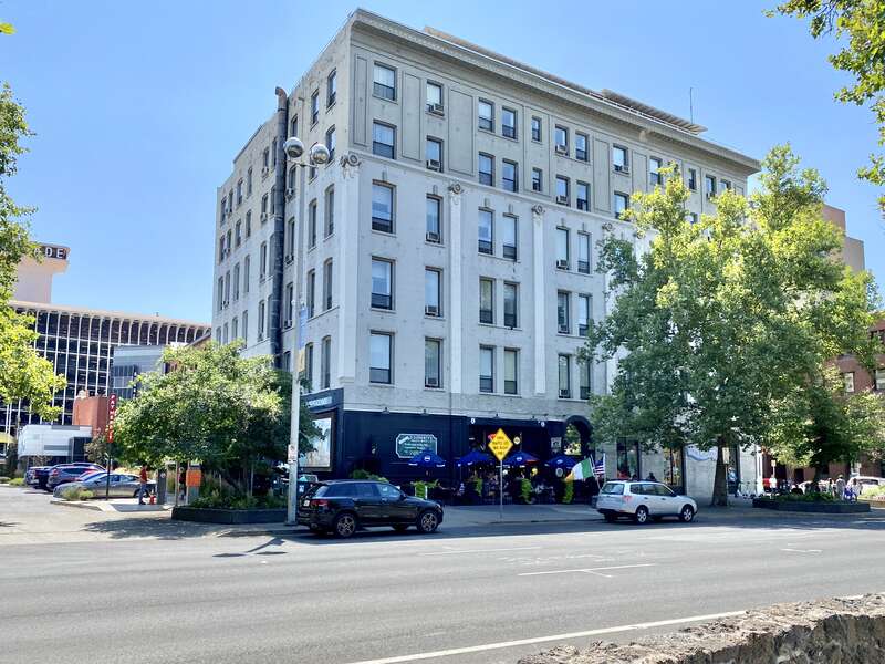 Built in 1890, this Renaissance Revival-style building features a painted brick exterior, pilasters with decorative capitals, replacement windows, a cornice with greek key motif, and a modified first floor facade.  The building today houses various