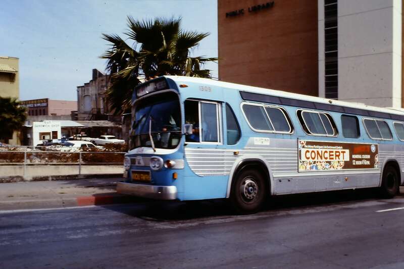 This bus was stopped on Schatzell St. next to the old library. The sign on the side promotes a Johnny Rodriquez concert.