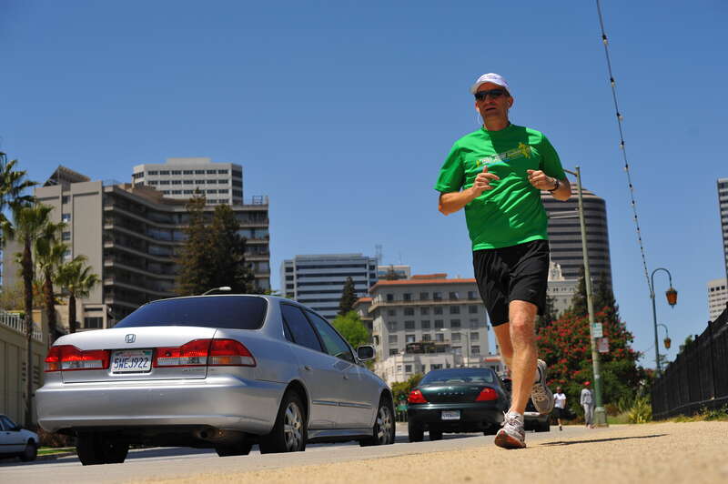 This former entrant in the Rock 'n Roll San Jose Half Marathon jogs along Lake Merritt on Saturday morning in Oakland, California.