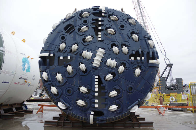 This bad girl is 19ft across and can cut through 70ft of hard rock in 34 hours.  She'll be put to work 5 days a week, and will rest on 6th and 7th days for sharpening her claws and what not.
Local school kids have named the tunnel boring machine
