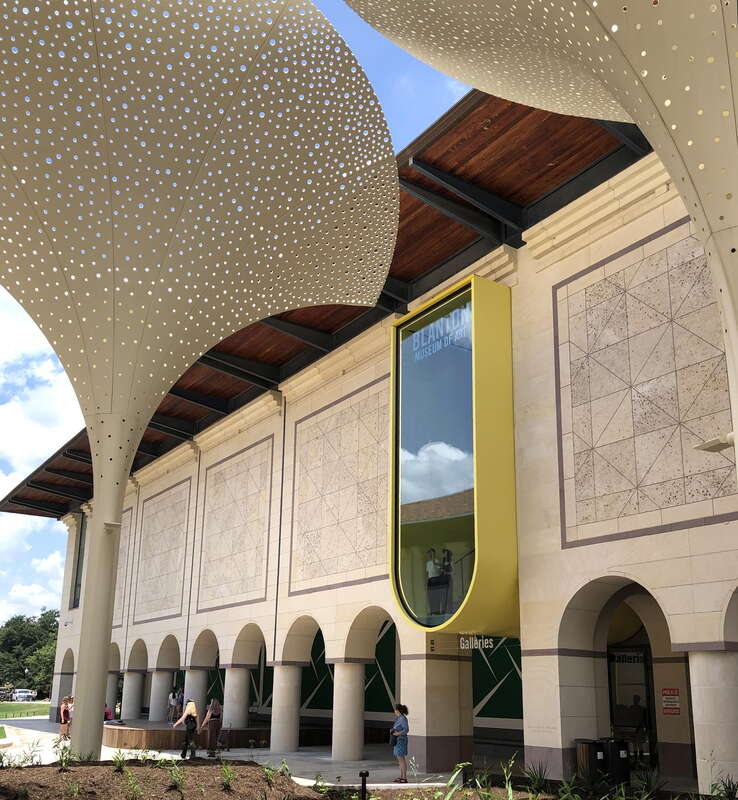 Exterior grounds and plaza designed by Snøhetta at the Blanton Museum of Art in Austin, Texas. Features include twelve towering, three-stories-tall &quot;petals&quot; which provide perforated shade. Other Snøhetta interventions include, above the main entrance