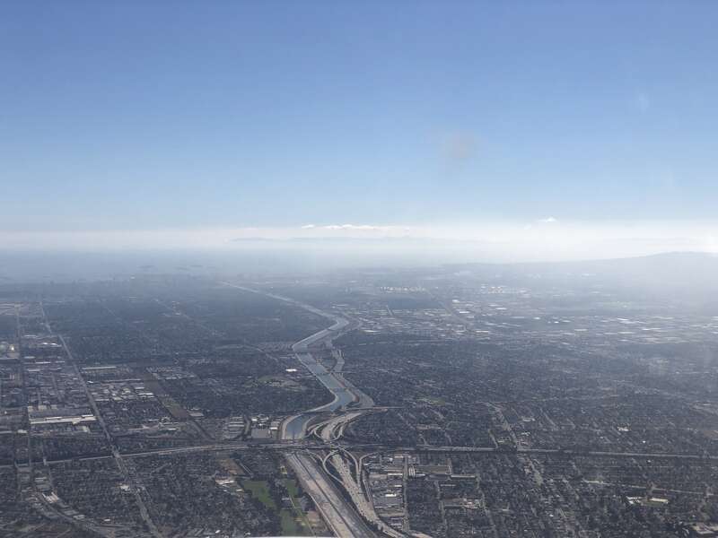 View southwest along the Los Angeles River and Interstate 710 towards the Port of Long Beach in southern Los Angeles County, California from an airplane heading toward Los Angeles International Airport