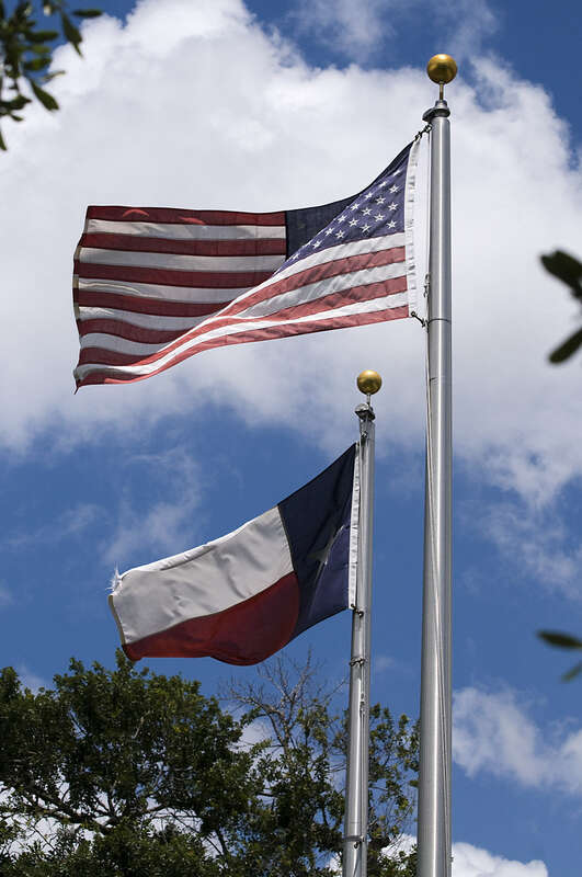 U.S. and Texas flags at the Butler Longhorn Museum Wild West Show in League City