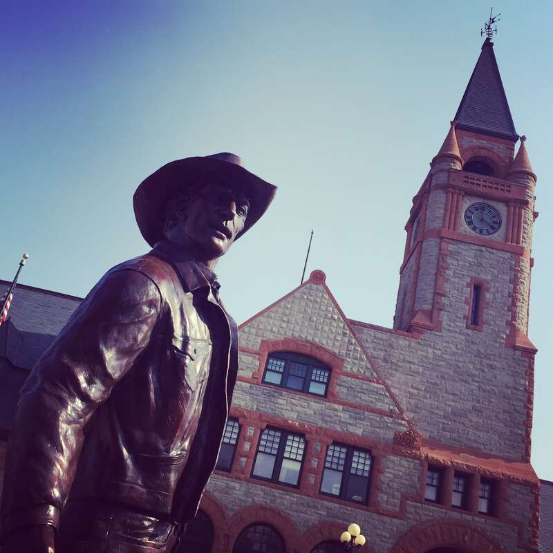 The bronze statue sits outside the train depot in Cheyenne and depicts a cowboy about to depart the city.