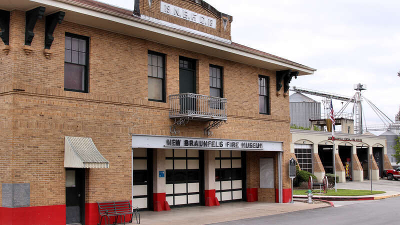The 1918 New Braunfels Fire Station (now the New Braunfels Fire Museum) in front of the current Central Fire Station in New Braunfels, Texas, United States.