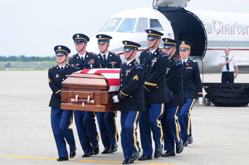 The North Dakota National Guard Military Funeral Honors team transfers the remains of U.S. Army Spc. Keenan Cooper upon arrival at the 119th Wing, North Dakota Air National Guard July 14, 2010. Cooper was killed in action while serving his country in