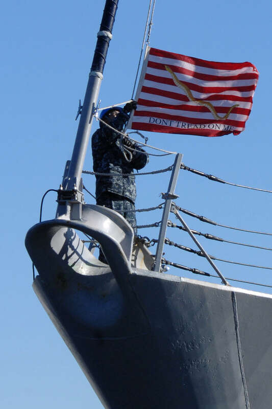 NORFOLK (Jan. 13, 2011) A Sailor lowers the Navy Jack aboard the Arleigh Burke-class guided-missile destroyer USS Bulkeley (DDG 84) as the ship gets underway at Naval Station Norfolk. Bulkeley is part of the Enterprise Carrier Strike Group, which is