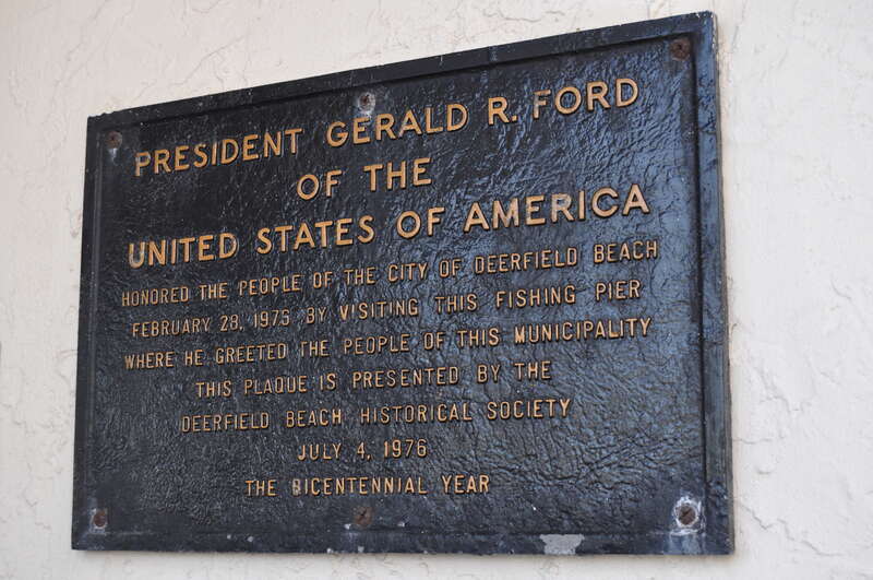 An historical plaque at the entrance to the Deerfield Beach, Florida fishing pier.