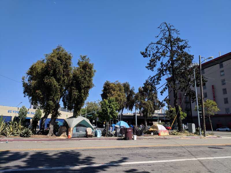 A small tent city near an onramp to Interstate 980 in Oakland, California.