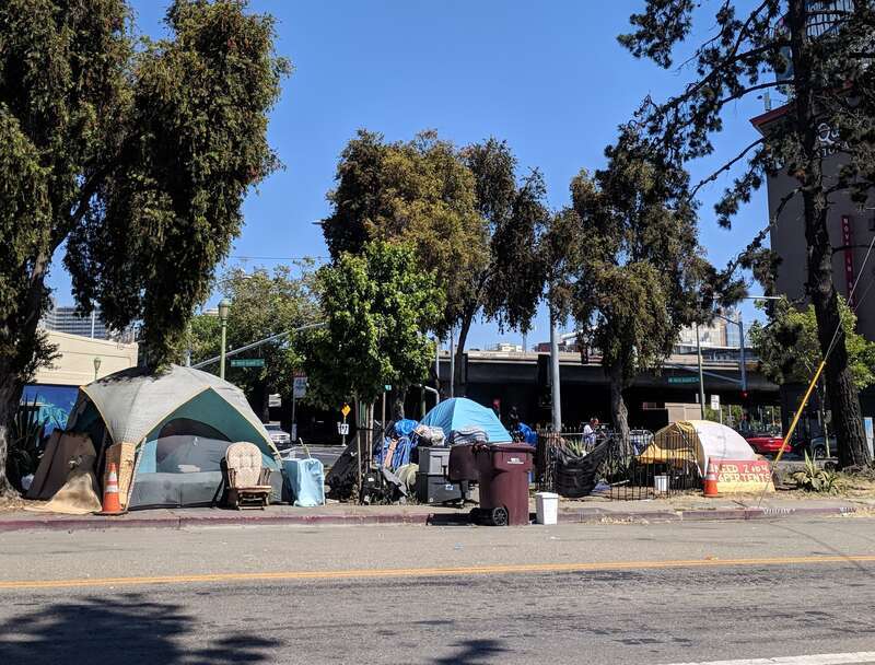 A small tent city near an onramp to Interstate 980 in Oakland, California.