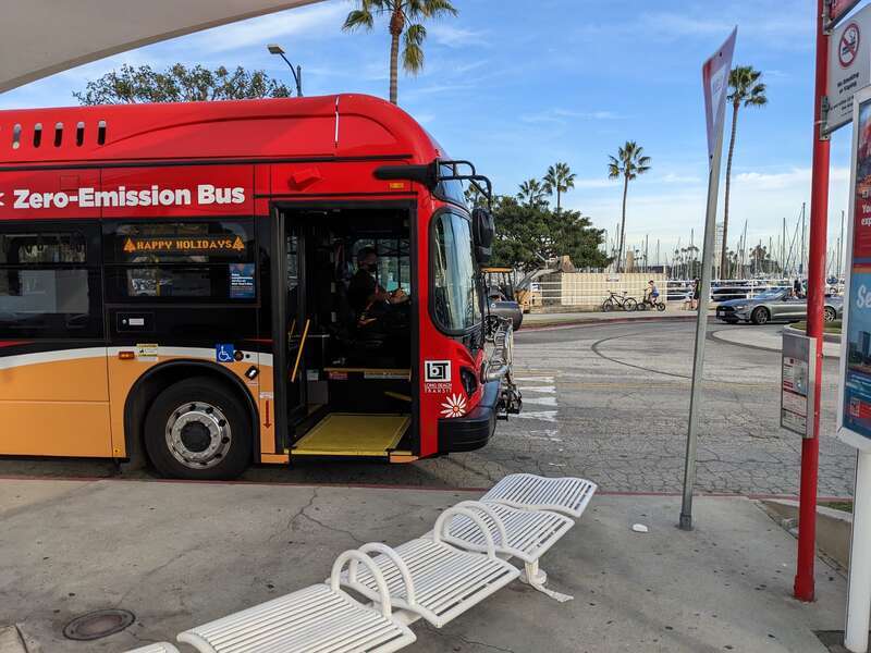The front right side of a BYD K9M bus operated by Long Beach Transit in December 2022