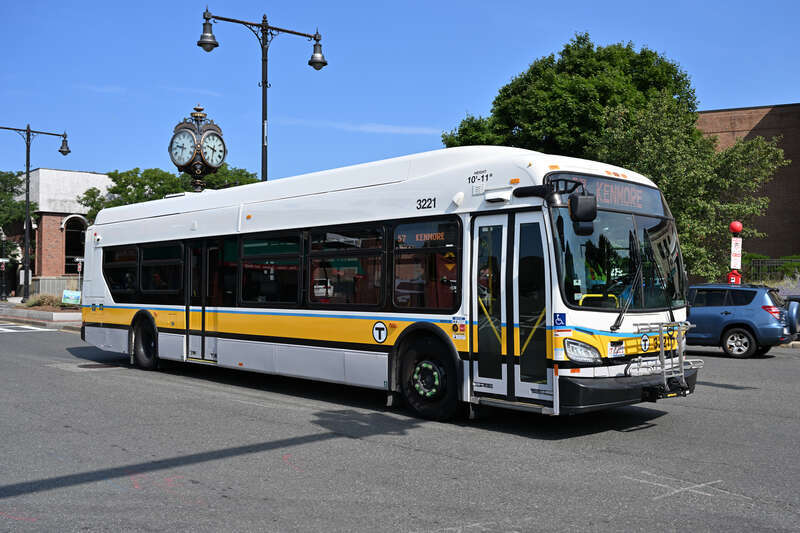 An MBTA New Flyer XDE40 bus on route 57 at Brighton Center in August 2024