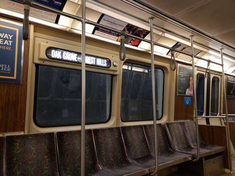 Interior of an MBTA Orange Line car 01292 (Bombardier 1200 series) at night in March 2018 while waiting at Oak Grove station