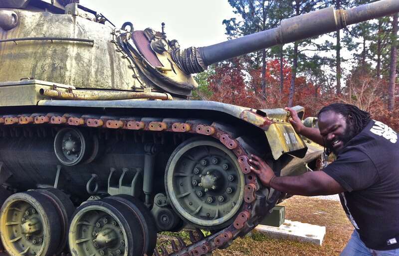 Mark Henry pushing a tank while visiting the North Carolina National Guard's Fayetteville armory on December 10, 2011.