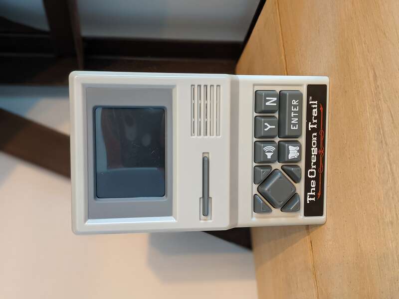 Oregon Trail handheld game, released in 2019. Re-release of original 1985 Apple II video game.