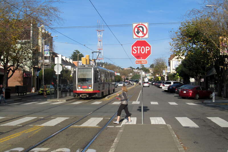 An outbound K Ingleside train on West Portal Avenue at 14th Avenue in December 2017