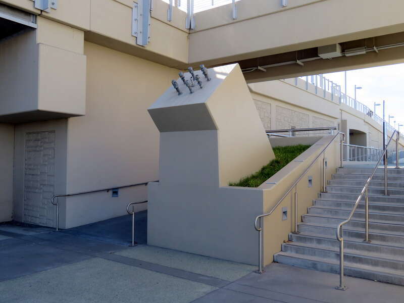 An angled pole base on the north side of San Bruno Avenue on the east side of San Bruno station in June 2018. Constructed with the station in 2014, it was intended for a gateway arch symbolically welcoming visitors to San Bruno that has not been