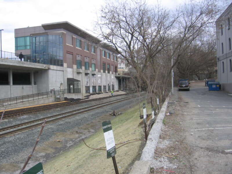 The Joseph Scelsi Intermodal Transportation Center in Pittsfield with track workers walking the line.