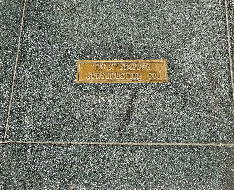 Sidewalk marker for Wm Simpson Construction Co. Located on the sidewalk adjacent to 719 Grand Ave., Los Angeles, California, USA.