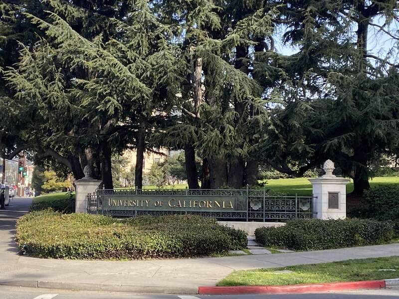 University of California sign on the UC Berkeley campus's Crescent Lawn.