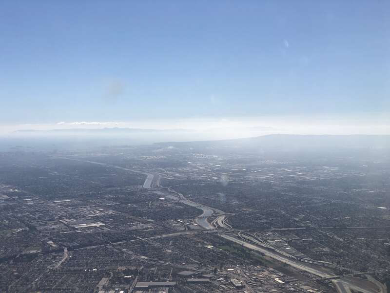 View southwest along the Los Angeles River and Interstate 710 towards the Port of Long Beach in southern Los Angeles County, California from an airplane heading toward Los Angeles International Airport