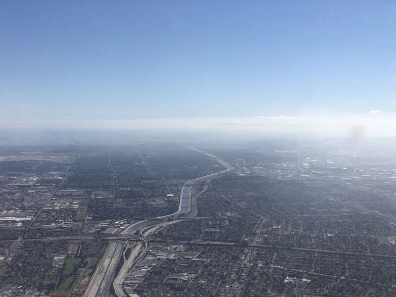 View southwest along the Los Angeles River and Interstate 710 towards the Port of Long Beach in southern Los Angeles County, California from an airplane heading toward Los Angeles International Airport