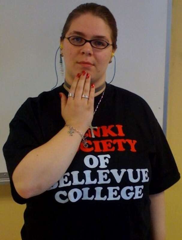 The first posture of the ASL sign THANK-YOU (wikt:en:OpenB@Chin-PalmBack OpenB@FromChin-PalmUp)