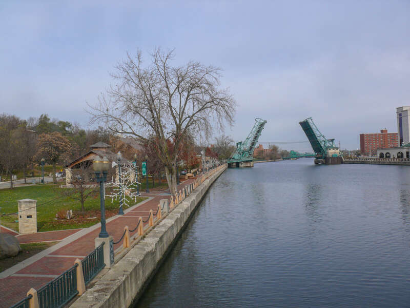 Billie Limacher Bicentennial Park, in Joliet, Illinois, with the Cass Street Bridge (opened for river traffic, on the Des Plaines River, or testing) in the background.  Farther away, the Jackson Street Bridge is also visible.