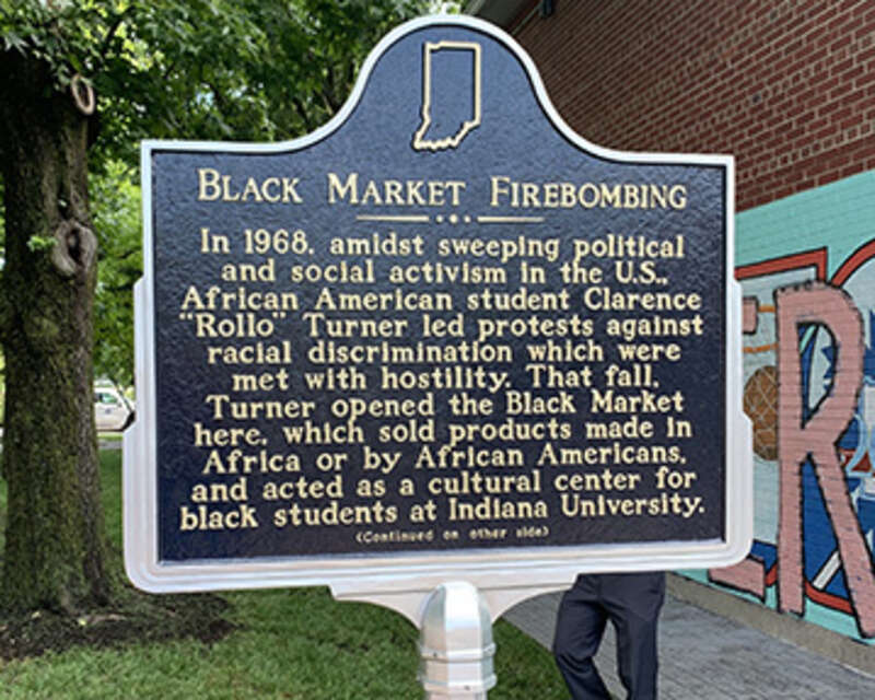 Side one of the Black Market Firebombing historical marker in Bloomington, Monroe County, Indiana.