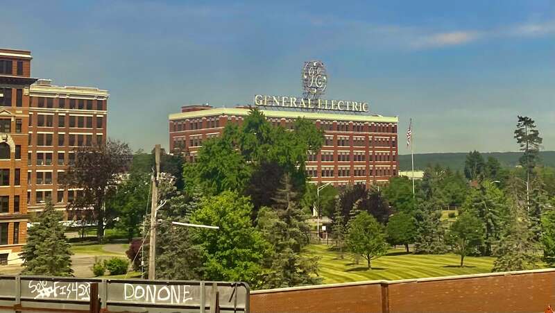 An iconic presence in the cityscape of Schenectady, New York is Building 37 of the General Electric Research and Development Center, as seen on a June 2022 morning from an Amtrak train pulling out of the downtown station. Built in 1925 as an