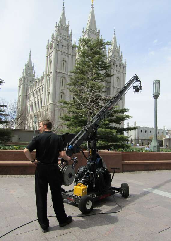 A cameraman waits on Temple Square to broadcast footage for the international broadcast of General Conference.
