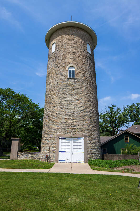 Water tower, Ellwood House, DeKalb, Illinois. &quot;On the west (rear) of the Ellwood House, the circular limestone water tower is about 50 feet (15.2 m) tall and has a diameter of 18 feet (5.5 m). The tower has windows occurring at different levels,