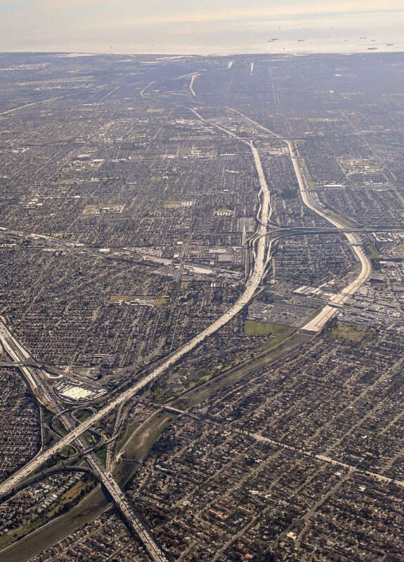 In this aerial view, the San Gabriel River (right of the I-605 here) changes from dirt to concrete channel in Downey, near the Rio San Gabriel Park (right center)