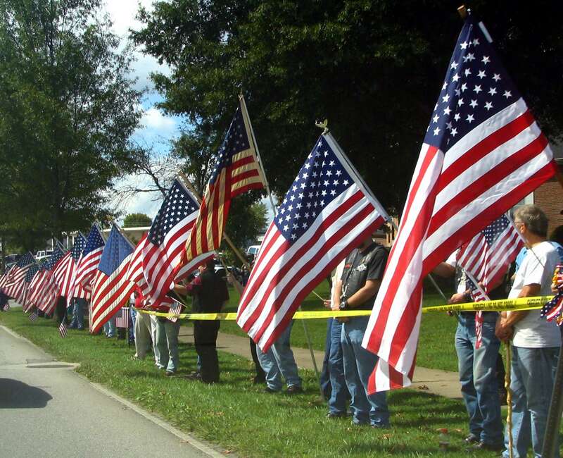 Bradley County residents lined Ocoee street in Cleveland, TN to show their support of Sgt. David Weir, who was recently killed in Iraq.  These flag wavers lined the street an hour early to see the funeral motorcade of the slain soldier.  One of the