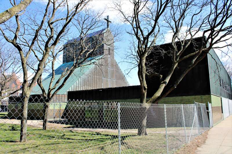 The former Cathedral of the Immaculate Conception in Burlington, Vermont. The property, which has been listed for sale, is now surrounded by a chain link fence.