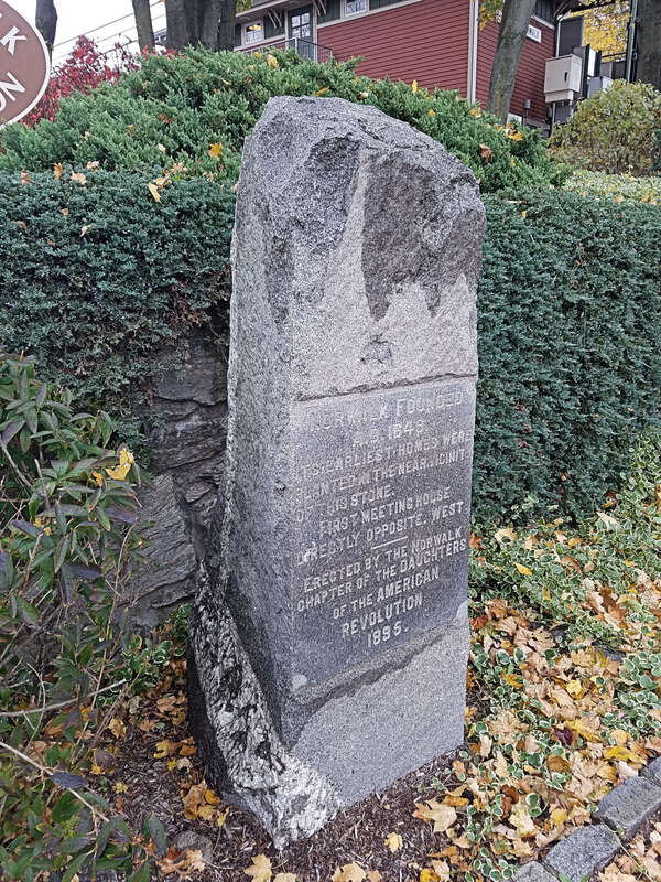 Granite stone marker erected by the Norwalk Chapter of Daughters of the American Revolution in 1895.  It marked an area where the earliest settlement in Norwalk once stood.  Now located near the driveway to the East Norwalk train station, it was