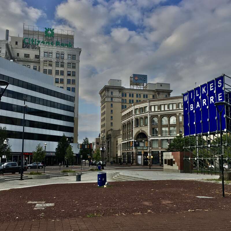 Looking northwestward down West Market Street from near the center of Public Square, Wilkes-Barre, Pennsylvania, September 2020. Seen at left are the BiCentennial Building (built 1976) in the foreground and the Citizens Bank Financial Center (1926)